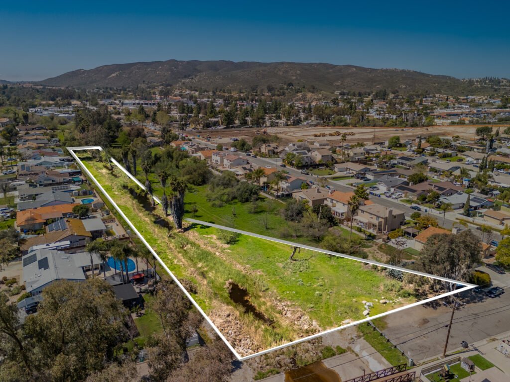 Aerial view of a vacant parcel with the lot boundary outlined