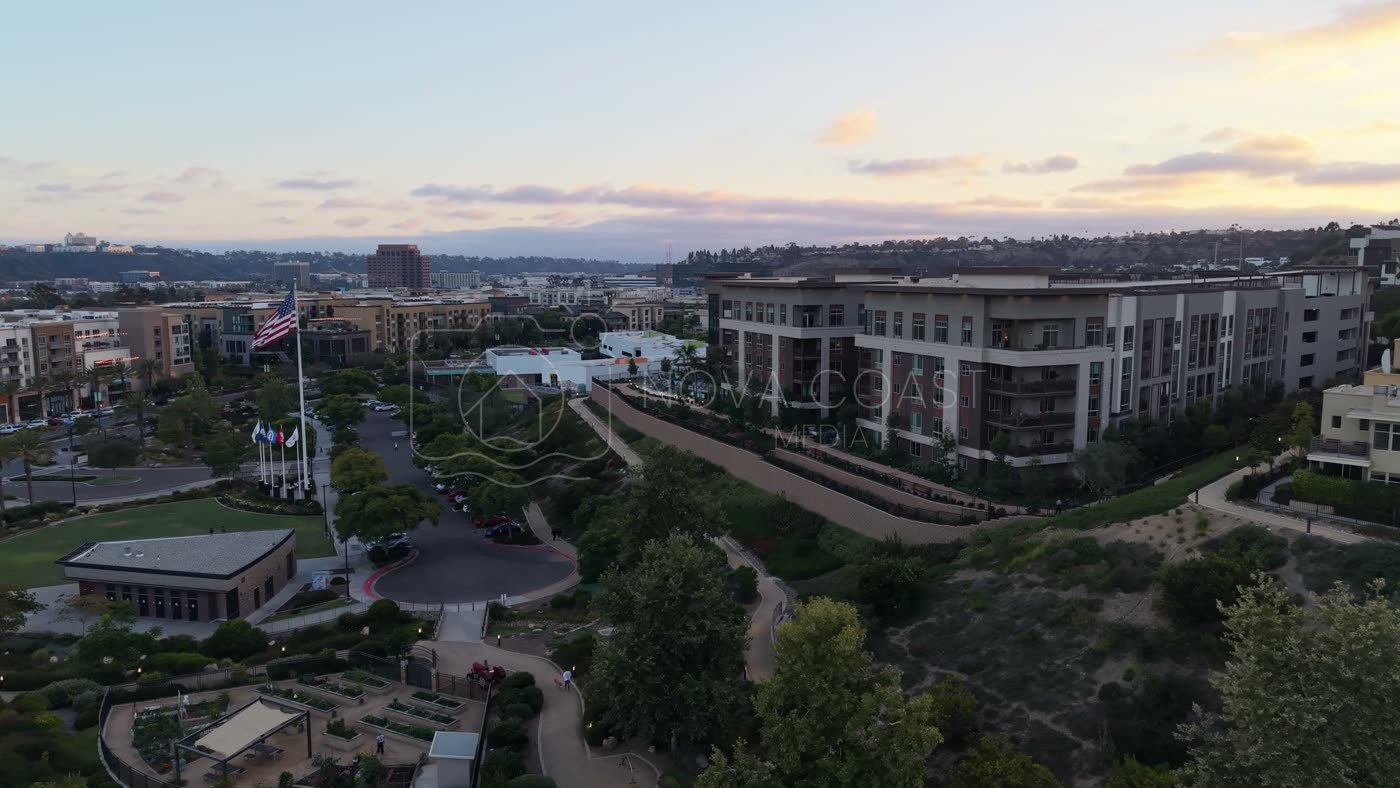 Civita Hilltop Residences Above the Community Garden Terraces at Dusk – Wide Establishing Frame