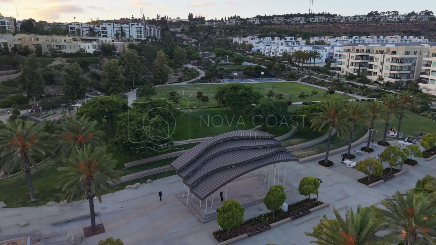 Civita Park Curved Steel Amphitheater Pavilion Above the Green – Wide Establishing Frame