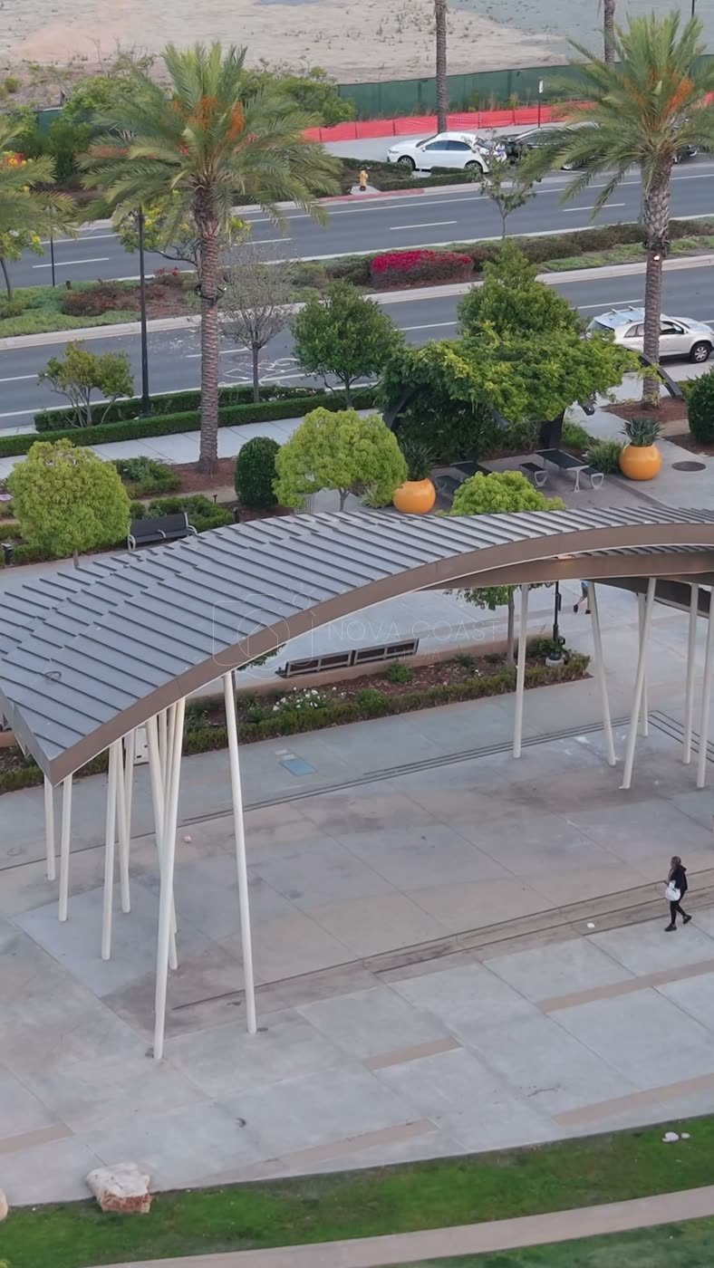 Architectural Detail of Civita Park’s Arched Canopy and Palm Plaza – Aerial View (Vertical)