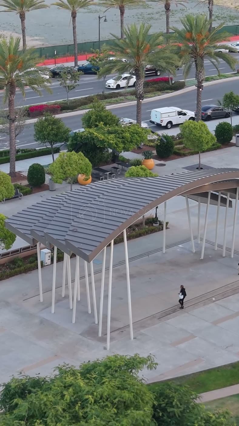 Architectural Detail of Civita Park’s Arched Canopy and Palm Plaza – Wide Establishing Frame (Vertical)