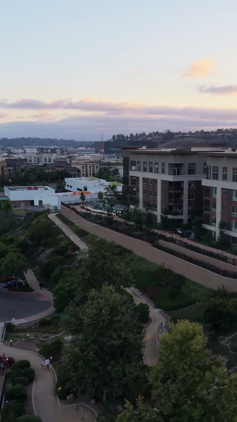 Civita Hilltop Residences Above the Community Garden Terraces at Dusk – Wide Establishing Frame (Vertical)
