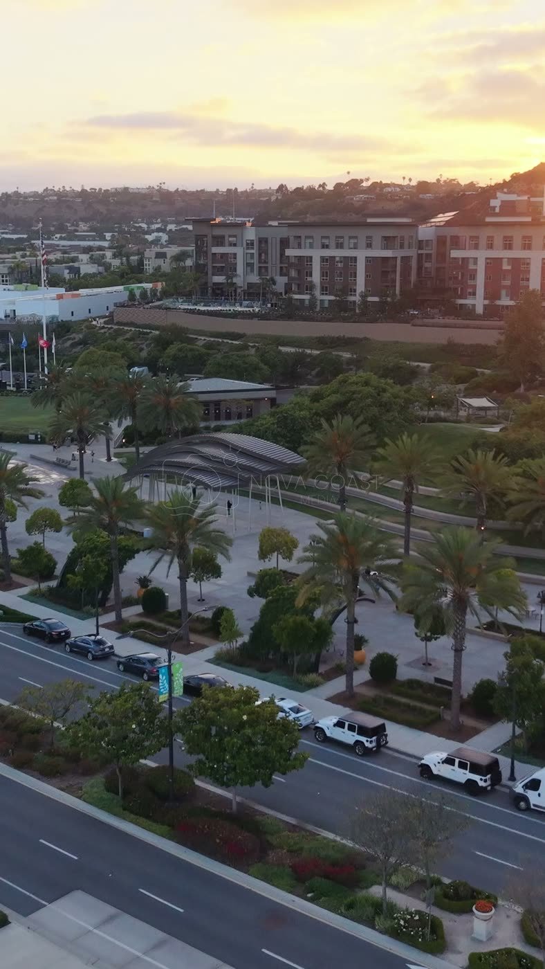 Civita Palm-Lined Boulevard and Park as the Sun Sets Over the Ridge – Aerial View (Vertical)