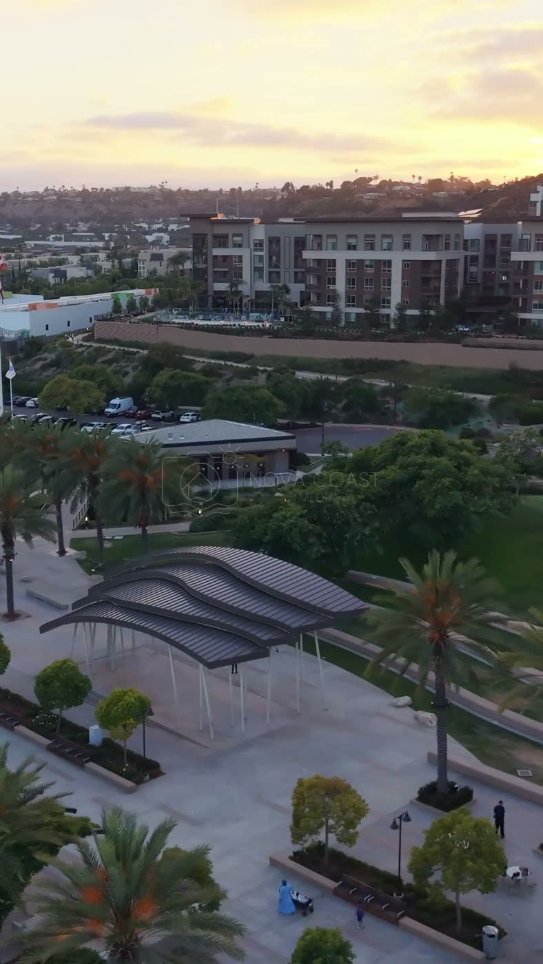 Civita Palm-Lined Boulevard and Park as the Sun Sets Over the Ridge – Wide Establishing Frame (Vertical)