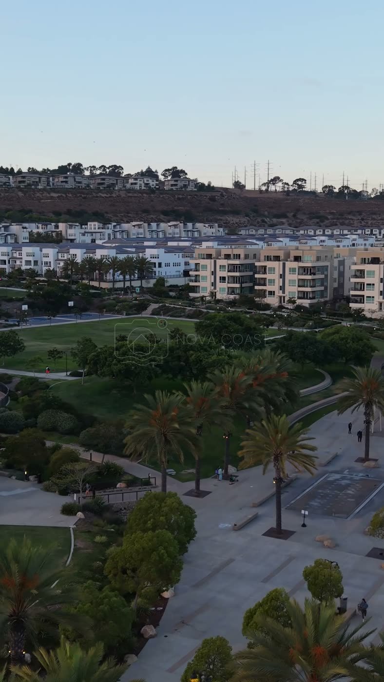 Civita Park Great Lawn and Flag Court Beside the Palm Promenade – Wide Establishing Frame (Vertical)