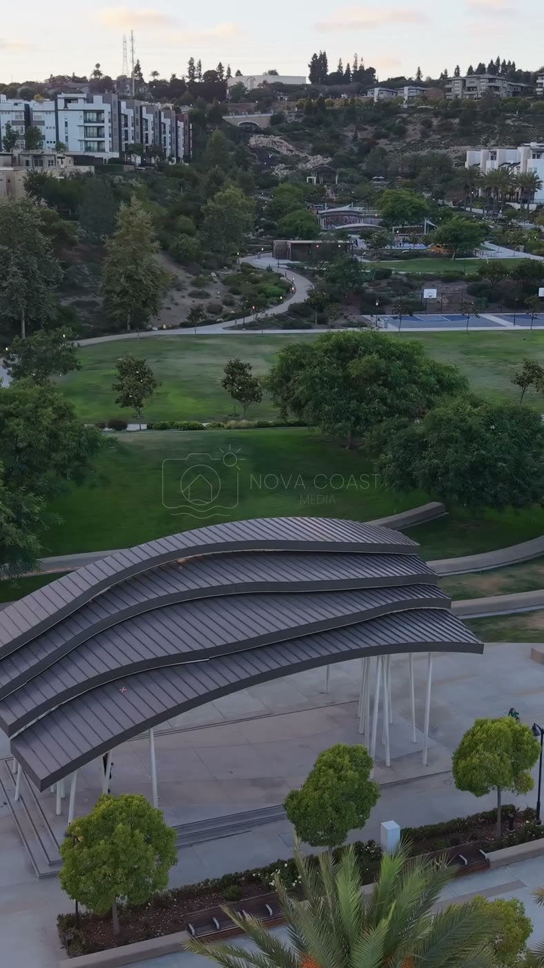 Civita Park Curved Steel Amphitheater Pavilion Above the Green – Aerial View (Vertical)