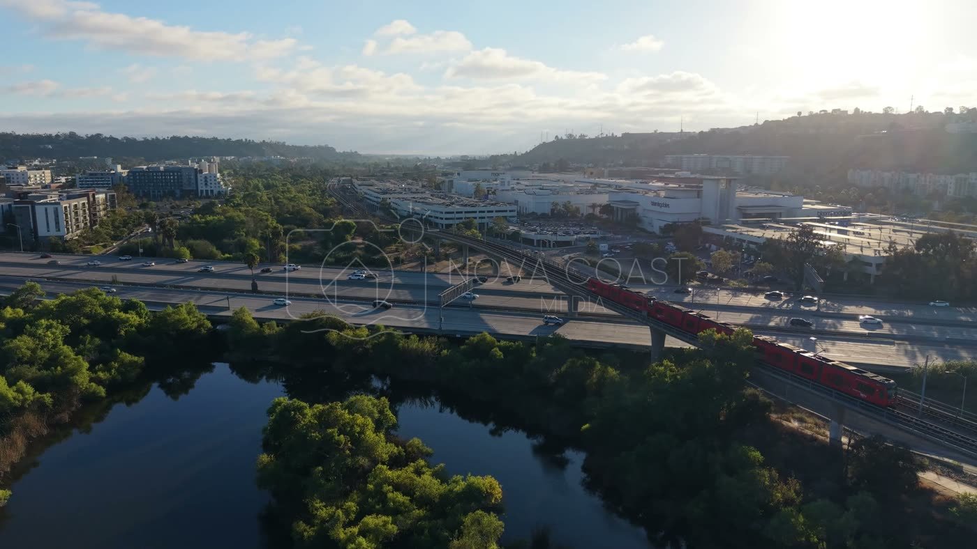 Trolley and Freeway Crossing the River Toward Mission Valley Mall at Sunset – Aerial View