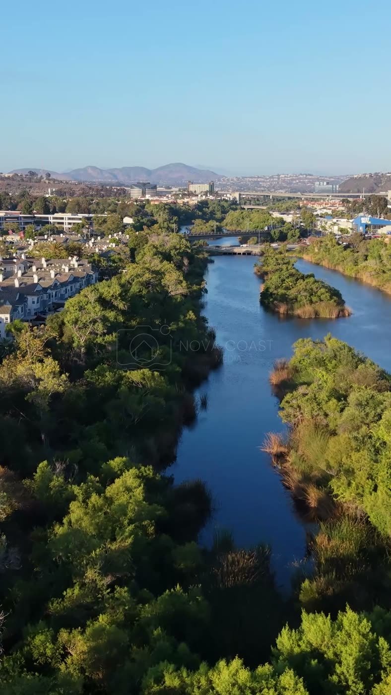 San Diego River Reflections Beside the Trolley Line and Office Tower – Wide Establishing Frame (Vertical)