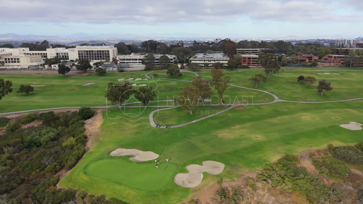 Golfers on the Green at Torrey Pines with the City Mesa Beyond – Wide Establishing Frame