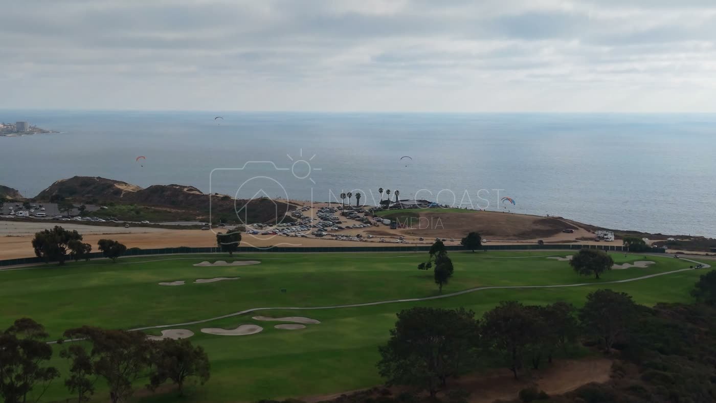 Torrey Pines Fairways with Paragliders Drifting Over the Sea – Aerial View