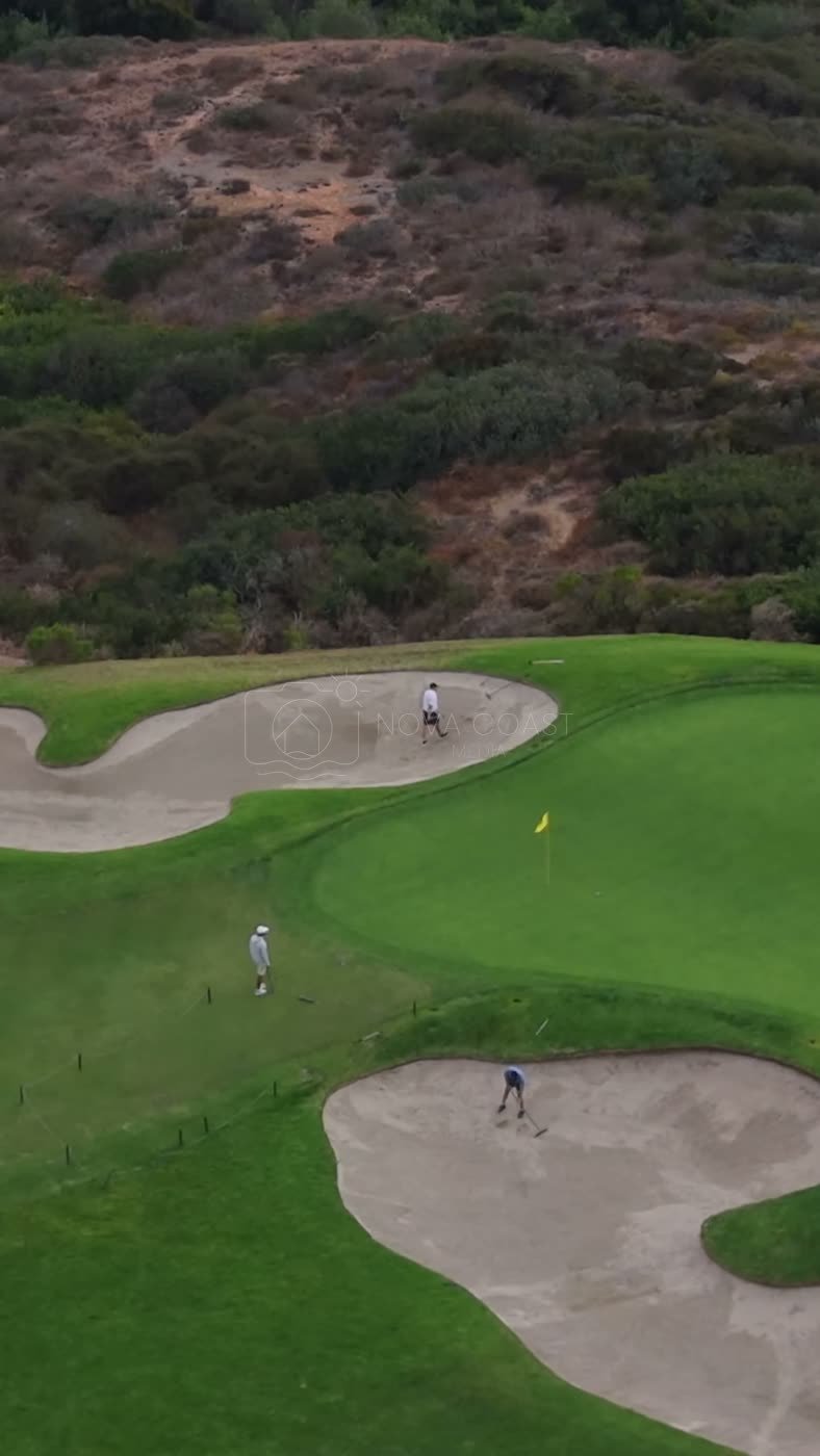 Golfers on a Clifftop Green Between Sculpted Bunkers at Torrey Pines – Aerial View (Vertical)