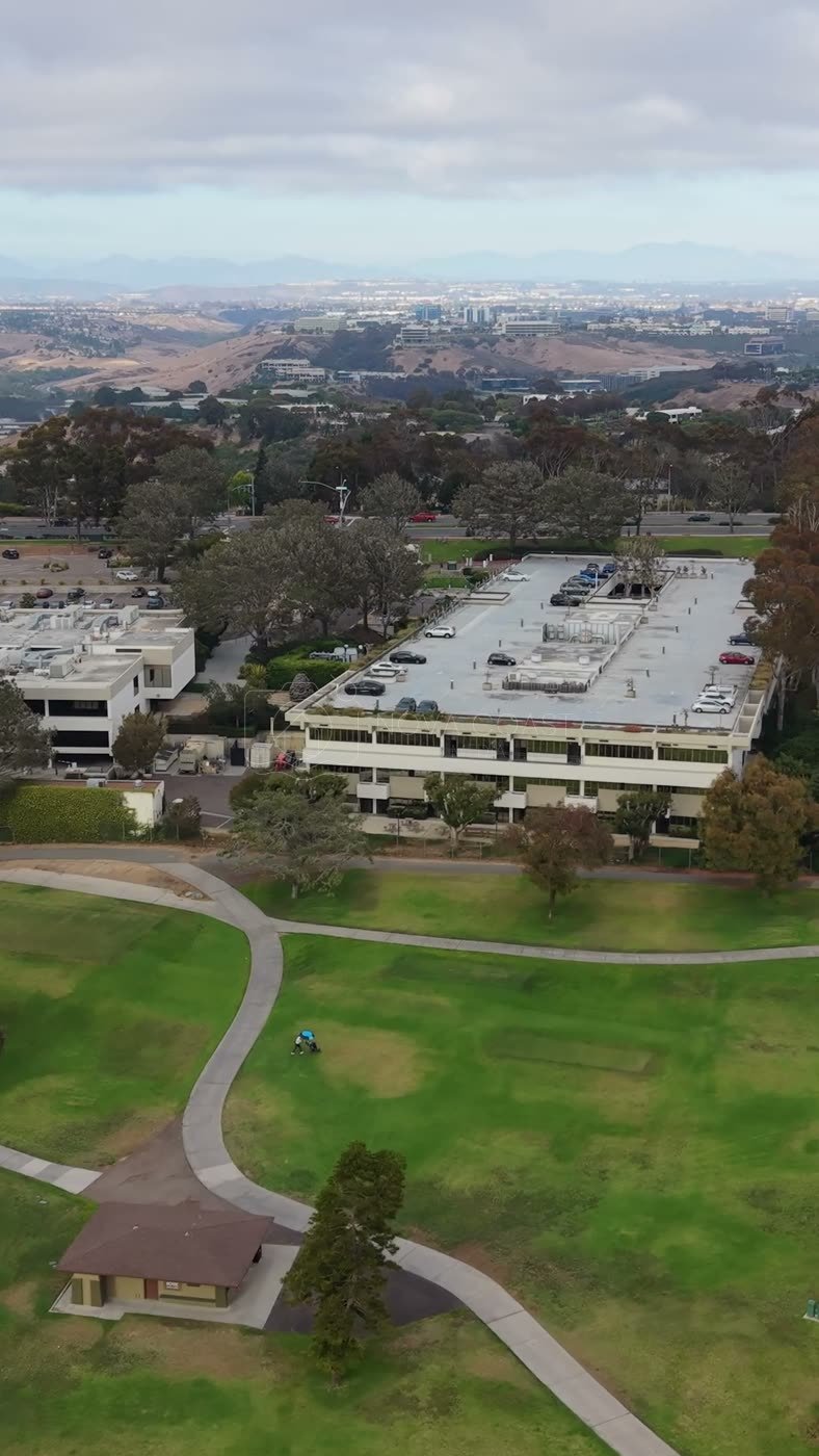 Torrey Pines Greens Beside the Science Park and Mesa Skyline – Wide Establishing Frame (Vertical)