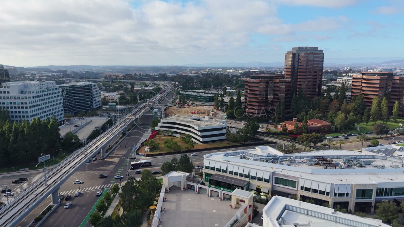 The Blue Line Trolley Threading Through University City’s Office District – Wide Establishing Frame