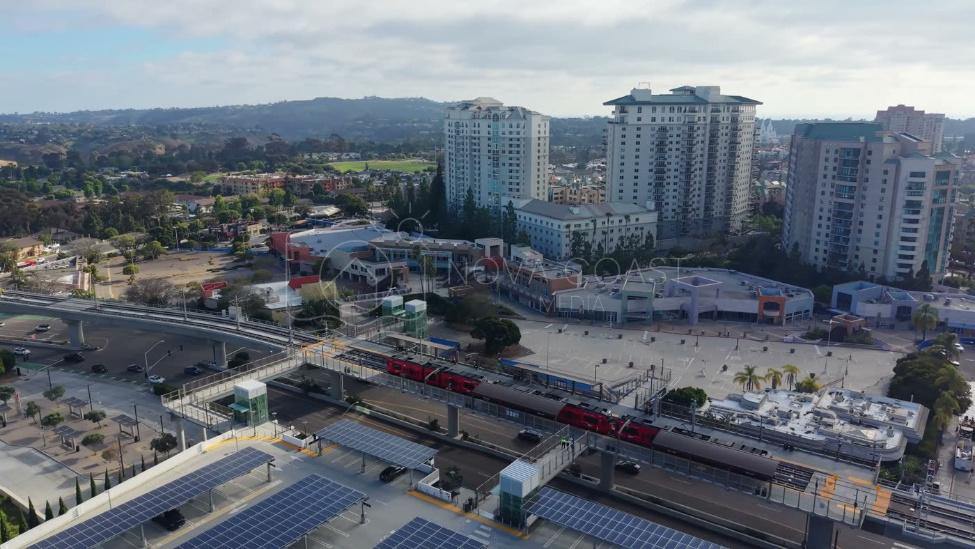 Trolley Arriving at the UTC Transit Center Below Residential Towers – Wide Establishing Frame