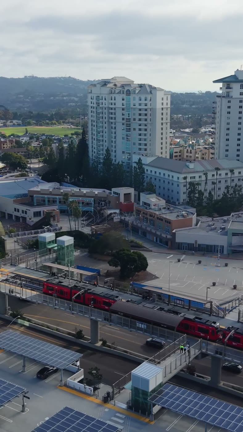 Trolley Arriving at the UTC Transit Center Below Residential Towers – Wide Establishing Frame (Vertical)
