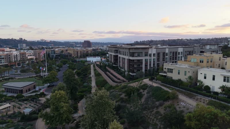 Civita Hilltop Residences Above the Community Garden Terraces at Dusk – Elevated Perspective
