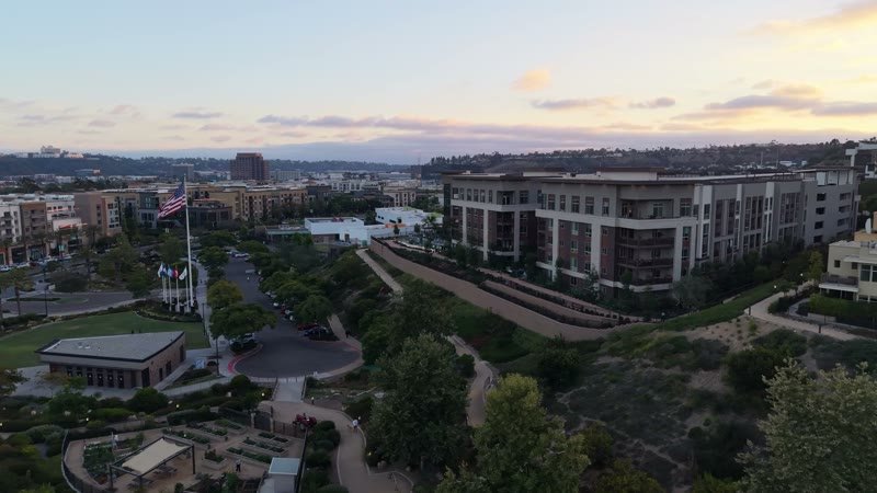 Civita Hilltop Residences Above the Community Garden Terraces at Dusk – Wide Establishing Frame