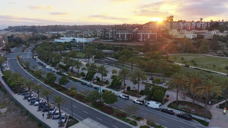 Civita Palm-Lined Boulevard and Park as the Sun Sets Over the Ridge – Aerial View