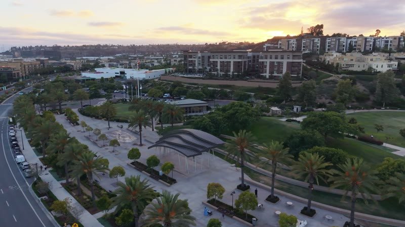 Civita Palm-Lined Boulevard and Park as the Sun Sets Over the Ridge – Wide Establishing Frame