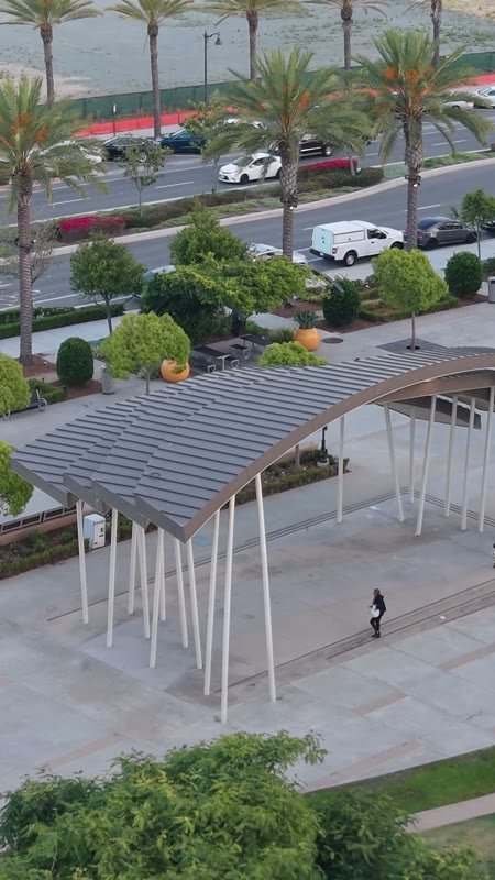 Architectural Detail of Civita Park’s Arched Canopy and Palm Plaza – Wide Establishing Frame (Vertical)