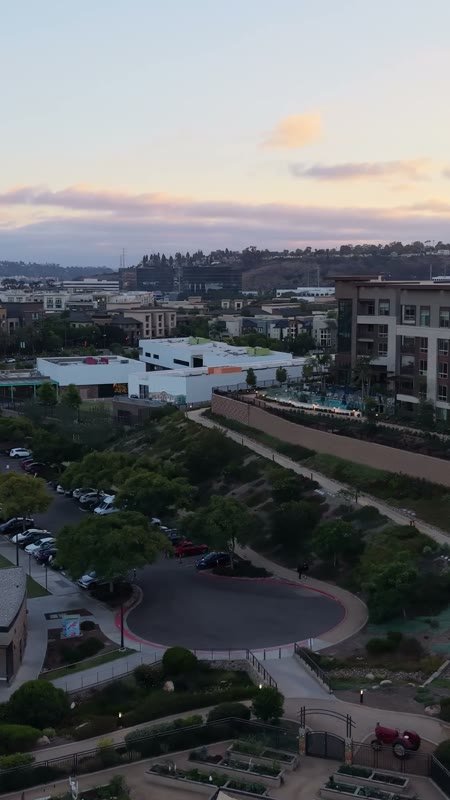 Civita Hilltop Residences Above the Community Garden Terraces at Dusk – Overhead Detail (Vertical)