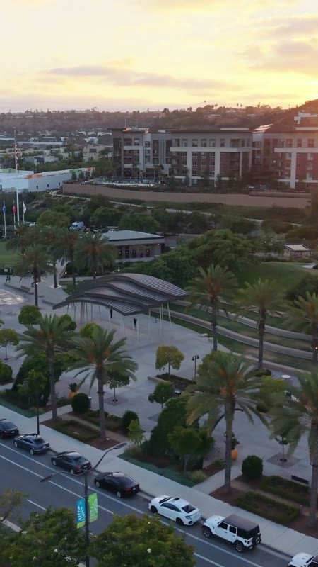 Civita Palm-Lined Boulevard and Park as the Sun Sets Over the Ridge – Elevated Perspective (Vertical)
