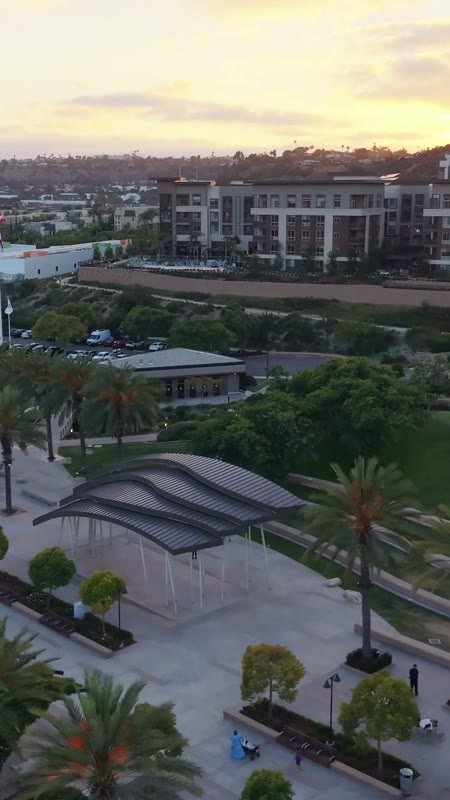 Civita Palm-Lined Boulevard and Park as the Sun Sets Over the Ridge – Wide Establishing Frame (Vertical)