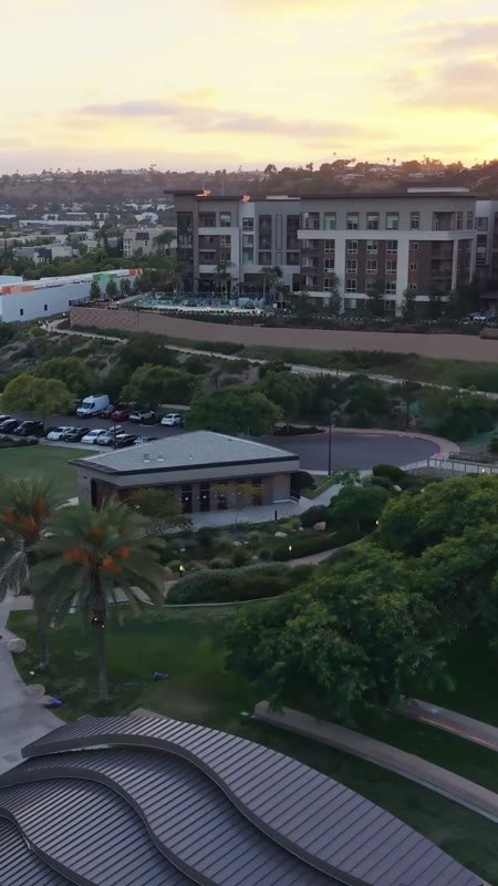 Civita Palm-Lined Boulevard and Park as the Sun Sets Over the Ridge – Overhead Detail (Vertical)