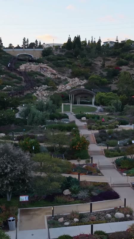 Civita Terraced Botanical Gardens and Winding Pathways at Twilight – Wide Establishing Frame (Vertical)