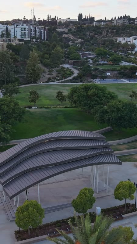 Civita Park Curved Steel Amphitheater Pavilion Above the Green – Aerial View (Vertical)