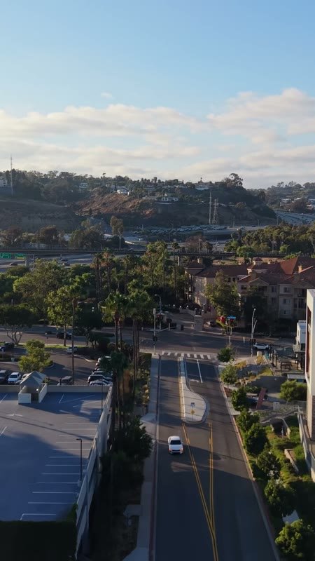Mission Valley Streetscape with Apartments and Freeway Beyond at Morning – Elevated Perspective (Vertical)