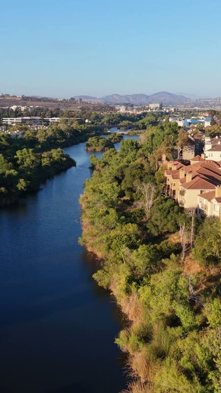San Diego River Winding Past Riverside Townhomes in Mission Valley – Aerial View (Vertical)