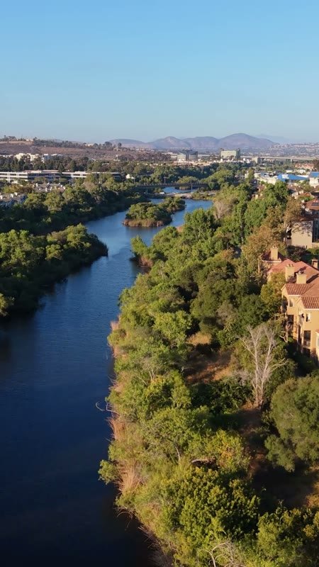 San Diego River Winding Past Riverside Townhomes in Mission Valley – Wide Establishing Frame (Vertical)
