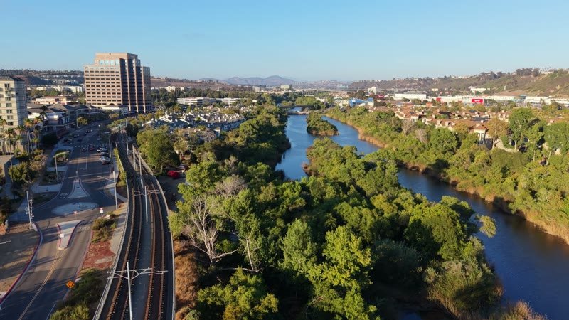 San Diego River Reflections Beside the Trolley Line and Office Tower – Aerial View