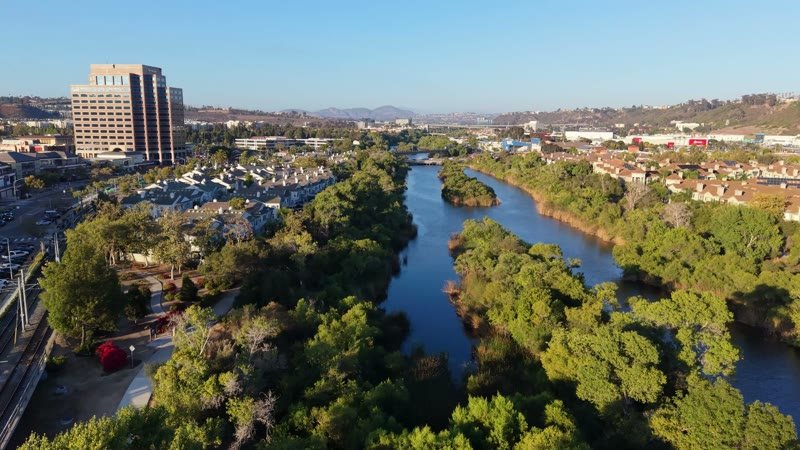 San Diego River Reflections Beside the Trolley Line and Office Tower – Wide Establishing Frame