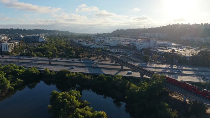 Trolley and Freeway Crossing the River Toward Mission Valley Mall at Sunset – Elevated Perspective