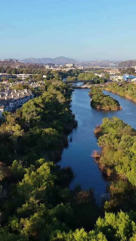 San Diego River Reflections Beside the Trolley Line and Office Tower – Wide Establishing Frame (Vertical)