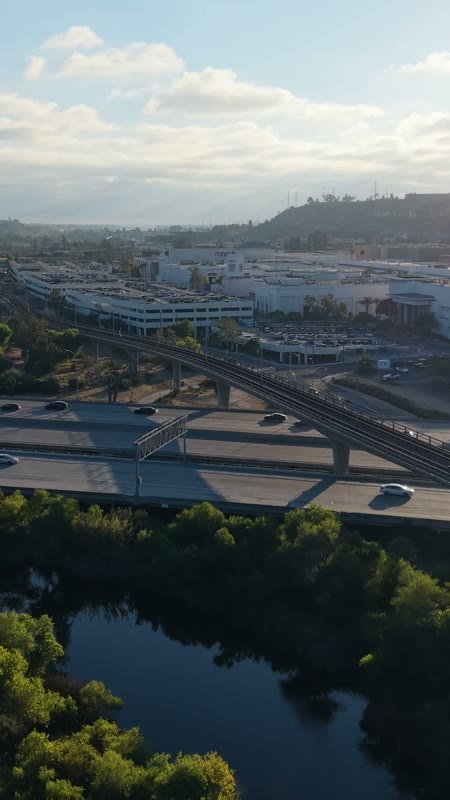 Trolley and Freeway Crossing the River Toward Mission Valley Mall at Sunset – Elevated Perspective (Vertical)