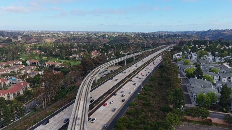Elevated Trolley Guideway Curving Above the I-5 in University City – Aerial View