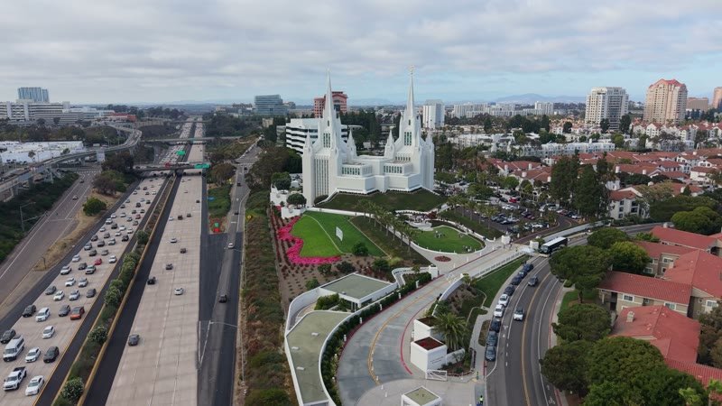 Twin-Spired San Diego Temple Above University City at Midday – Aerial View