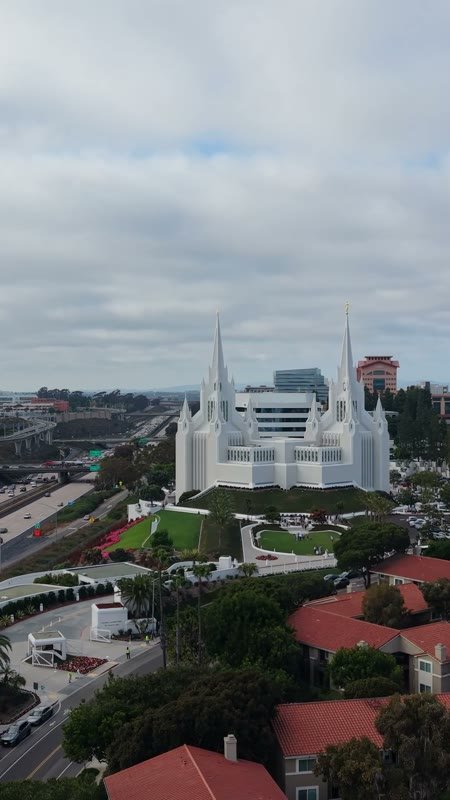 San Diego Temple Rising Beyond University City Rooftops – Wide Establishing Frame (Vertical)