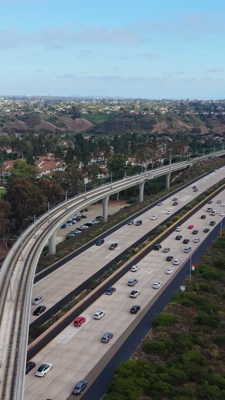 Elevated Trolley Guideway Curving Above the I-5 in University City – Aerial View (Vertical)