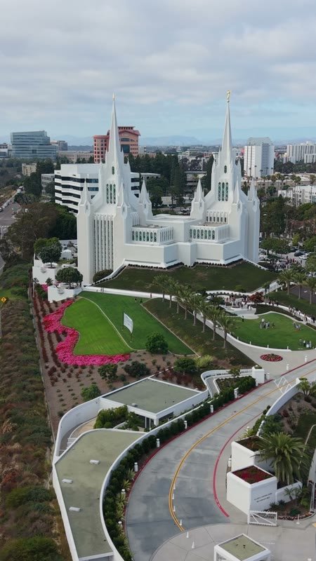 Twin-Spired San Diego Temple Above University City at Midday – Aerial View (Vertical)
