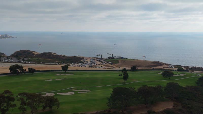 Torrey Pines Fairways with Paragliders Drifting Over the Sea – Aerial View