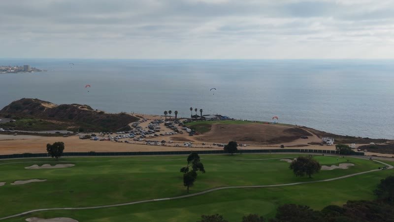 Torrey Pines Fairways with Paragliders Drifting Over the Sea – Golden Hour Frame