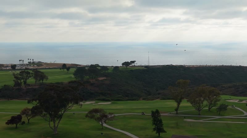 Distant Paragliders Over the Pacific Beyond Torrey Pines Fairways – Aerial View
