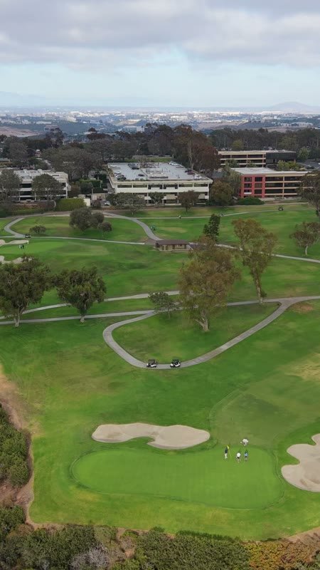 Golfers on the Green at Torrey Pines with the City Mesa Beyond – Aerial View (Vertical)