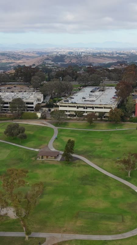 Torrey Pines Greens Beside the Science Park and Mesa Skyline – Aerial View (Vertical)