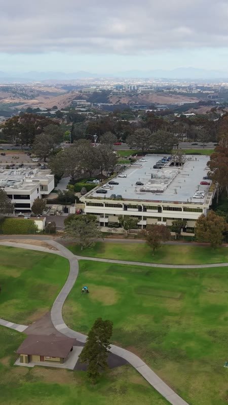 Torrey Pines Greens Beside the Science Park and Mesa Skyline – Wide Establishing Frame (Vertical)