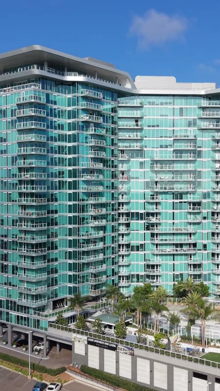 Glass High-Rise Residences at University Town Center Under Blue Skies (Vertical)